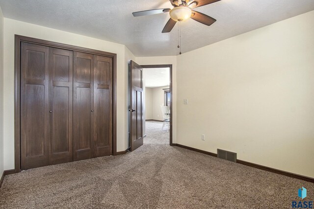 26017 Hideaway Pl, Canistota, SD 57012 - unfurnished bedroom featuring carpet, a closet, and ceiling fan