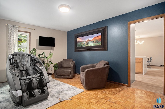 201 W Elm St, Luverne, MN 56156 - living area featuring a chandelier and baseboards