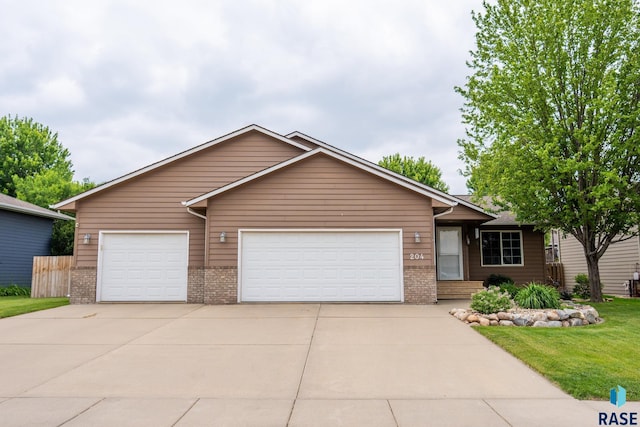 204 W Mountain Ash St, Brandon, SD 57005 - ranch-style house featuring driveway, brick siding, a garage, and a front lawn