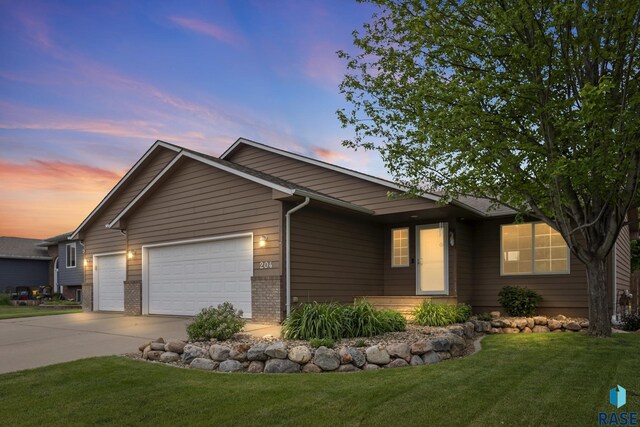 204 W Mountain Ash St, Brandon, SD 57005 - single story home featuring an attached garage, concrete driveway, a front yard, and brick siding