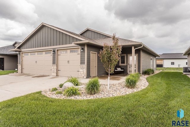 252 Devitt Dr, Harrisburg, SD 57032 - view of front of property featuring board and batten siding, a garage, concrete driveway, and a front lawn
