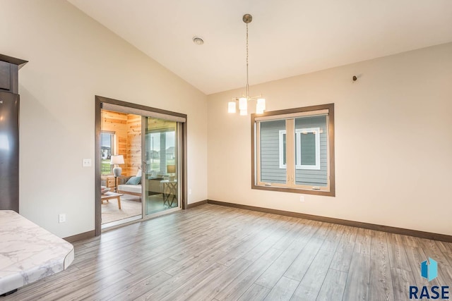 252 Devitt Dr, Harrisburg, SD 57032 - unfurnished room with a chandelier, light wood-style flooring, and lofted ceiling
