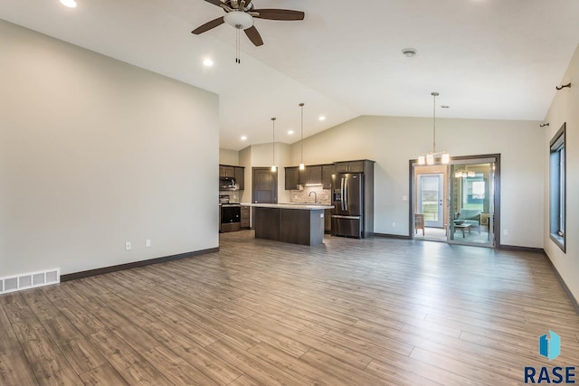 252 Devitt Dr, Harrisburg, SD 57032 - unfurnished living room featuring a ceiling fan, wood finished floors, high vaulted ceiling, and recessed lighting