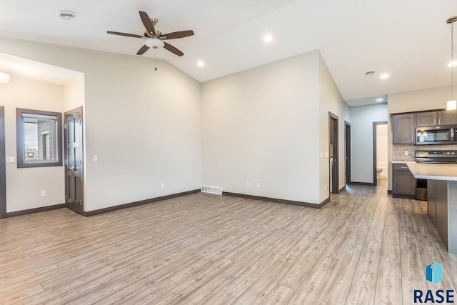 252 Devitt Dr, Harrisburg, SD 57032 - unfurnished living room with light wood finished floors, a ceiling fan, and lofted ceiling
