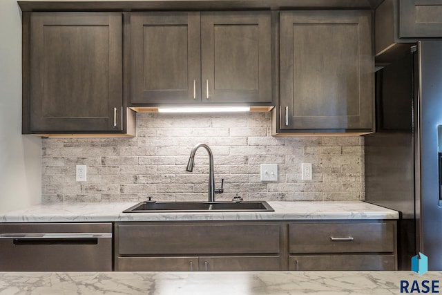 252 Devitt Dr, Harrisburg, SD 57032 - kitchen featuring stainless steel appliances, dark brown cabinetry, tasteful backsplash, and light stone counters