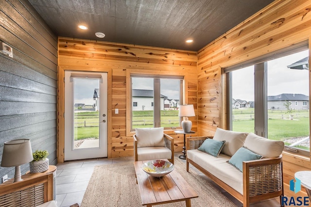 252 Devitt Dr, Harrisburg, SD 57032 - living room with healthy amount of natural light, wooden walls, recessed lighting, and light tile patterned floors