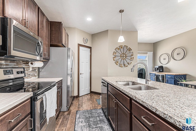 511 S 2nd Ave, Sioux Falls, SD 57104 - kitchen with appliances with stainless steel finishes, backsplash, dark brown cabinetry, dark wood-type flooring, and recessed lighting
