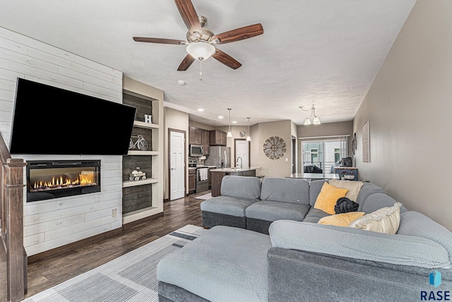 511 S 2nd Ave, Sioux Falls, SD 57104 - living area featuring dark wood-type flooring, ceiling fan, a large fireplace, and built in features