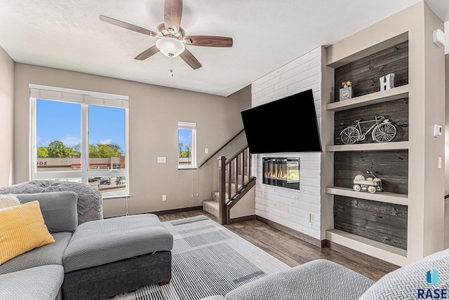 511 S 2nd Ave, Sioux Falls, SD 57104 - living room featuring stairway, wood finished floors, ceiling fan, a fireplace, and built in features