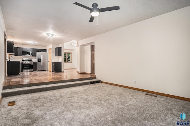 7604 E Palomino Rd, Sioux Falls, SD 57110 - unfurnished living room featuring carpet flooring and ceiling fan