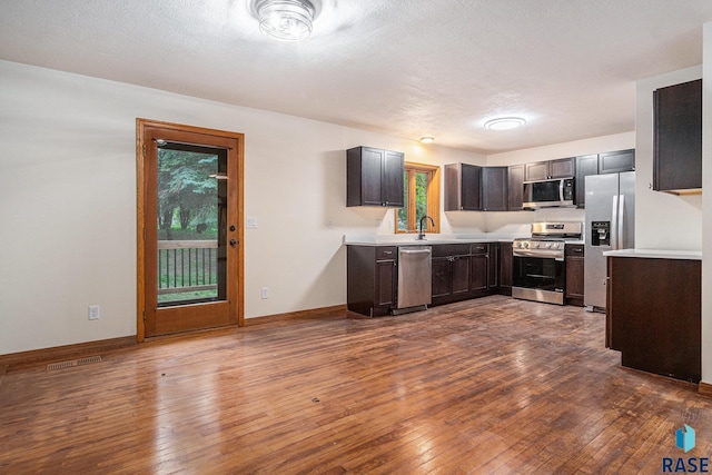 7604 E Palomino Rd, Sioux Falls, SD 57110 - kitchen featuring stainless steel appliances, light countertops, and dark wood finished floors