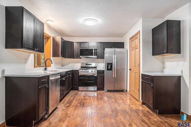 7604 E Palomino Rd, Sioux Falls, SD 57110 - kitchen with stainless steel appliances, wood finished floors, and light countertops
