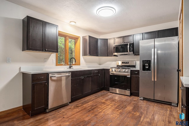 7604 E Palomino Rd, Sioux Falls, SD 57110 - kitchen featuring appliances with stainless steel finishes, dark wood-type flooring, light countertops, and dark brown cabinetry