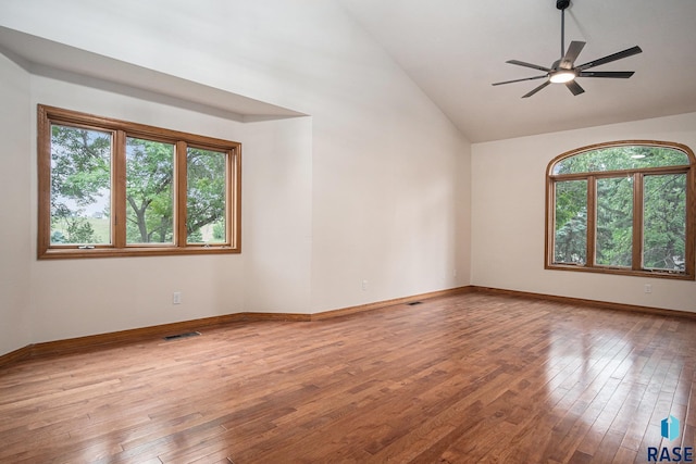 7604 E Palomino Rd, Sioux Falls, SD 57110 - unfurnished room featuring plenty of natural light, hardwood / wood-style floors, ceiling fan, and high vaulted ceiling