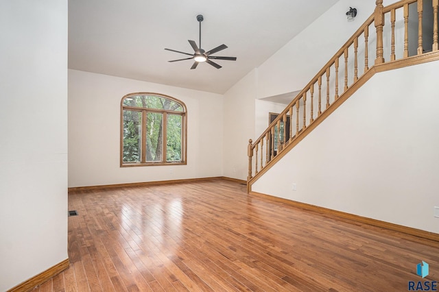 7604 E Palomino Rd, Sioux Falls, SD 57110 - unfurnished living room with ceiling fan, stairway, hardwood / wood-style flooring, and high vaulted ceiling