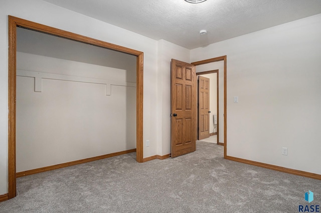 7604 E Palomino Rd, Sioux Falls, SD 57110 - unfurnished bedroom with carpet floors, a closet, and a textured ceiling