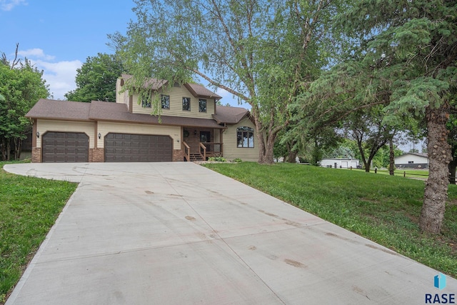 7604 E Palomino Rd, Sioux Falls, SD 57110 - view of front of property featuring concrete driveway, a front yard, brick siding, and a garage