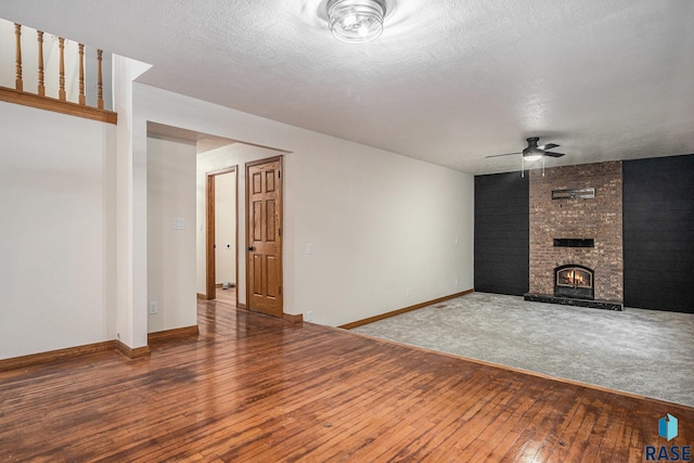 7604 E Palomino Rd, Sioux Falls, SD 57110 - unfurnished living room featuring ceiling fan, wood-type flooring, and a fireplace