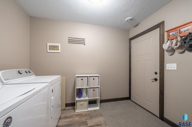 217 E Antioch St, Tea, SD 57064 - laundry area featuring independent washer and dryer, a textured ceiling, and light wood-style flooring