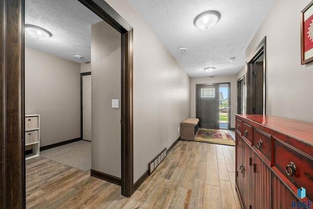 217 E Antioch St, Tea, SD 57064 - hallway featuring a textured ceiling and light wood finished floors
