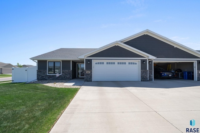 217 E Antioch St, Tea, SD 57064 - view of front of property with a garage, driveway, and stone siding