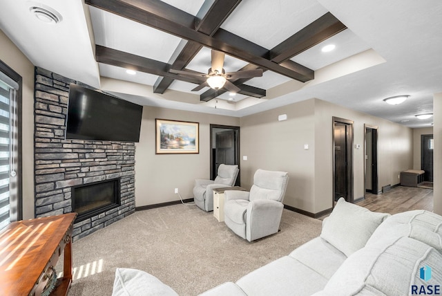 217 E Antioch St, Tea, SD 57064 - living room featuring coffered ceiling, a stone fireplace, beam ceiling, light colored carpet, and ceiling fan