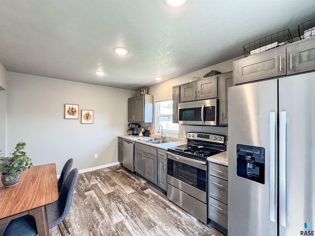 704 S Sneve Ave, Sioux Falls, SD 57103 - kitchen with stainless steel appliances, light countertops, wood finished floors, recessed lighting, and gray cabinets
