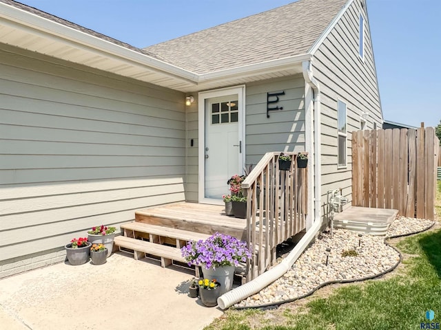 704 S Sneve Ave, Sioux Falls, SD 57103 - view of exterior entry with a shingled roof and a deck