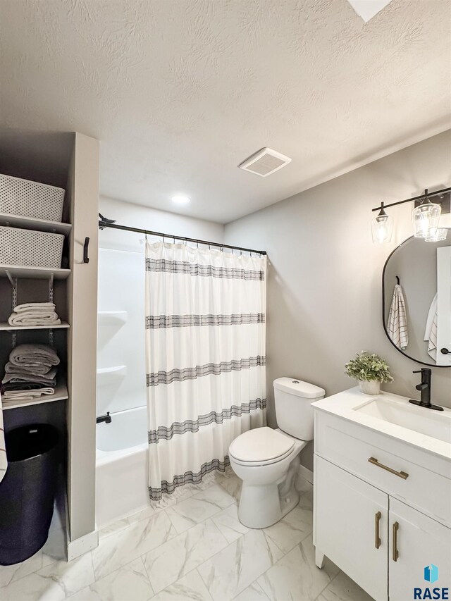 704 S Sneve Ave, Sioux Falls, SD 57103 - full bath with marble finish floors, vanity, shower / bath combo, and a textured ceiling