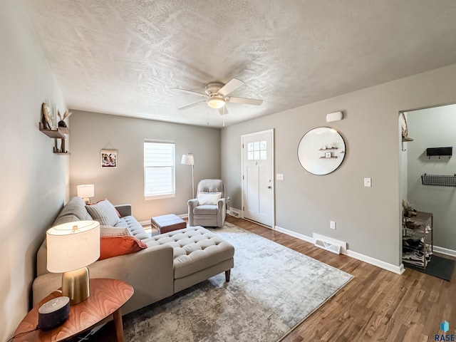 704 S Sneve Ave, Sioux Falls, SD 57103 - living room with a ceiling fan, wood finished floors, and a textured ceiling