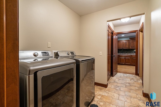 5509 E Eastbridge Pl, Sioux Falls, SD 57110 - washroom with washer and dryer and stone tile flooring