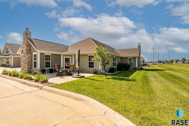 5509 E Eastbridge Pl, Sioux Falls, SD 57110 - back of house featuring stone siding, a patio area, a lawn, and a chimney