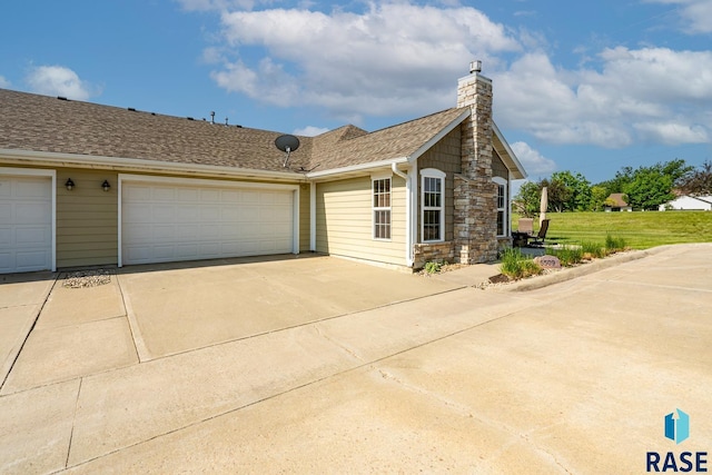 5509 E Eastbridge Pl, Sioux Falls, SD 57110 - view of front of house featuring driveway, a chimney, and an attached garage