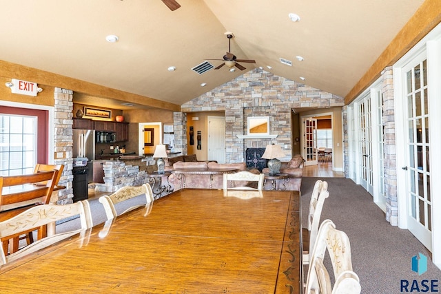 5509 E Eastbridge Pl, Sioux Falls, SD 57110 - dining area with a ceiling fan, a stone fireplace, vaulted ceiling, french doors, and recessed lighting
