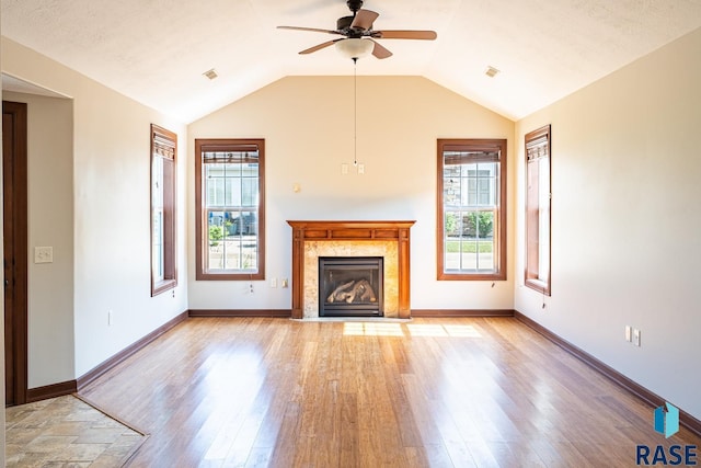 5509 E Eastbridge Pl, Sioux Falls, SD 57110 - unfurnished living room featuring a ceiling fan, a high end fireplace, light wood-style flooring, and vaulted ceiling