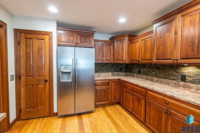 5509 E Eastbridge Pl, Sioux Falls, SD 57110 - kitchen with stainless steel refrigerator with ice dispenser, light wood finished floors, tasteful backsplash, and recessed lighting