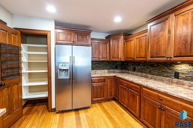 5509 E Eastbridge Pl, Sioux Falls, SD 57110 - kitchen with stainless steel fridge, light wood-style floors, decorative backsplash, and recessed lighting