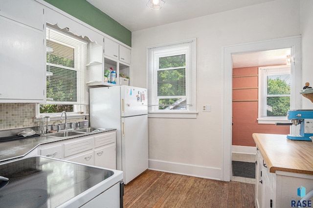 229 N Trapp Ave, Sioux Falls, SD 57104 - kitchen with freestanding refrigerator, wood finished floors, white cabinets, and plenty of natural light