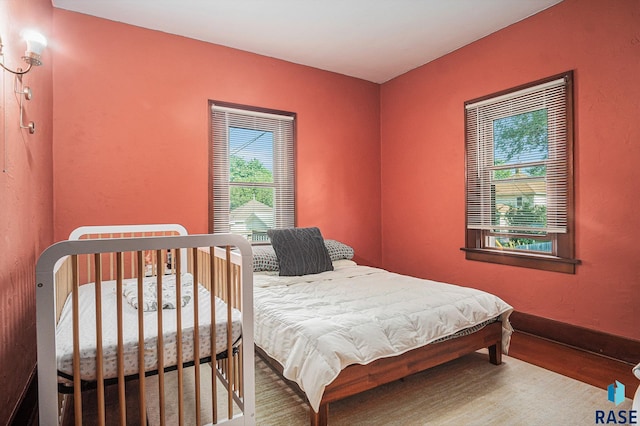 229 N Trapp Ave, Sioux Falls, SD 57104 - bedroom with multiple windows and wood finished floors