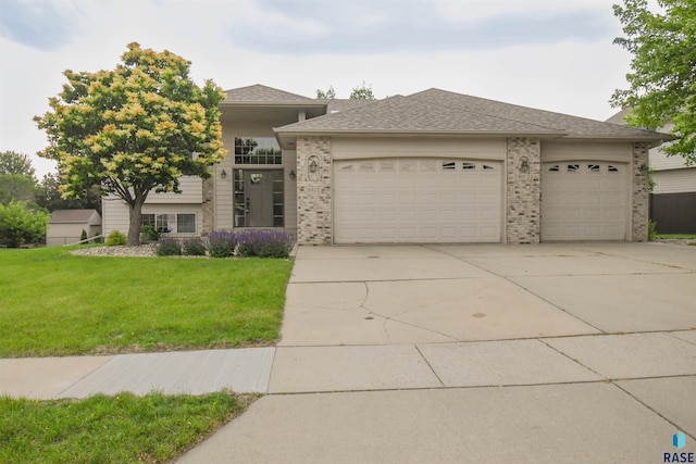 6312 S Heatherridge Ave, Sioux Falls, SD 57108 - view of front of property with an attached garage, concrete driveway, a front lawn, and brick siding