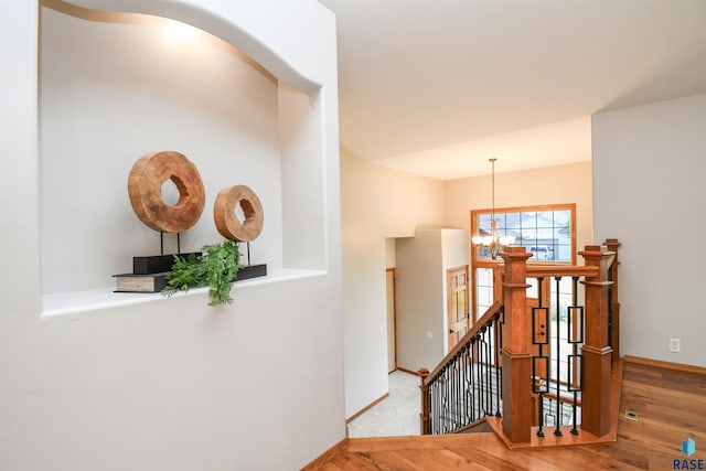 6312 S Heatherridge Ave, Sioux Falls, SD 57108 - hall featuring an upstairs landing, a chandelier, and wood finished floors