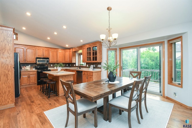 6312 S Heatherridge Ave, Sioux Falls, SD 57108 - dining area with a chandelier, recessed lighting, vaulted ceiling, and light wood-type flooring