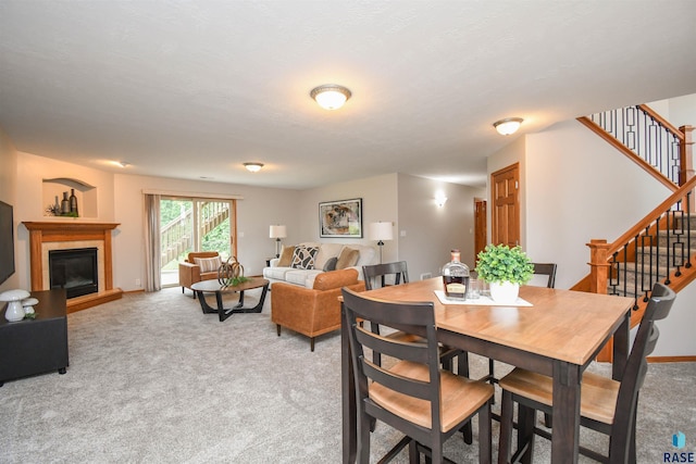 6312 S Heatherridge Ave, Sioux Falls, SD 57108 - dining space with light carpet, stairs, and a fireplace