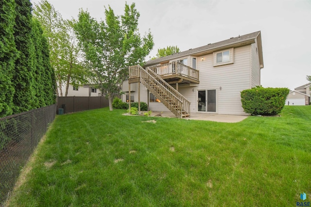 6312 S Heatherridge Ave, Sioux Falls, SD 57108 - rear view of house with stairs, a fenced backyard, a wooden deck, and a patio
