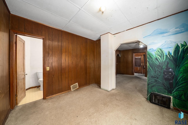 1407 N Main Ave, Sioux Falls, SD 57104 - empty room with wood walls, arched walkways, and light carpet
