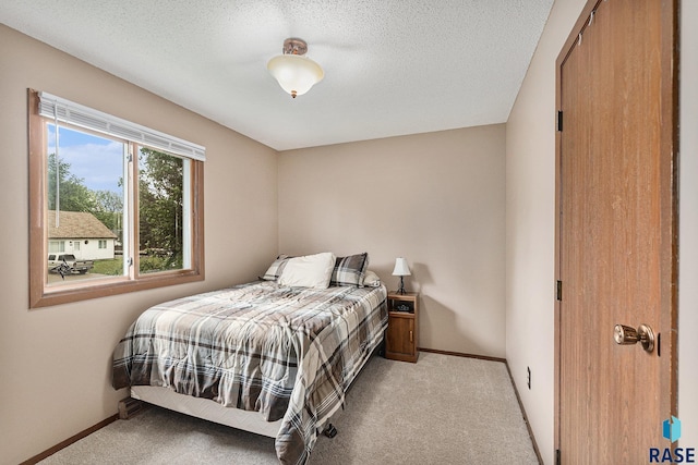 5909 W Bakker Park Dr, Sioux Falls, SD 57106 - carpeted bedroom with baseboards and a textured ceiling
