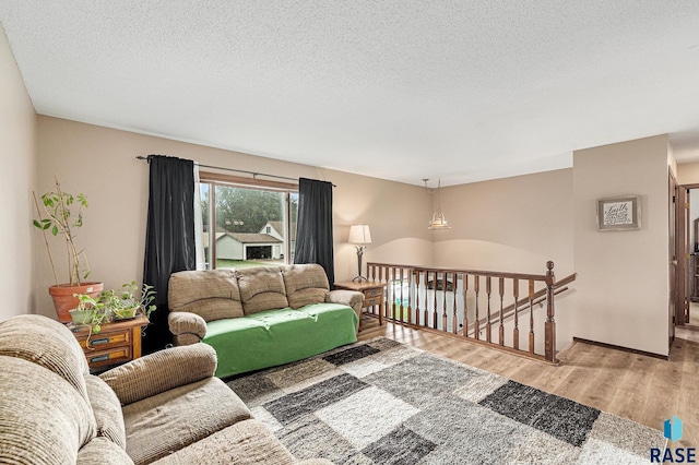 5909 W Bakker Park Dr, Sioux Falls, SD 57106 - living room featuring wood finished floors and a textured ceiling