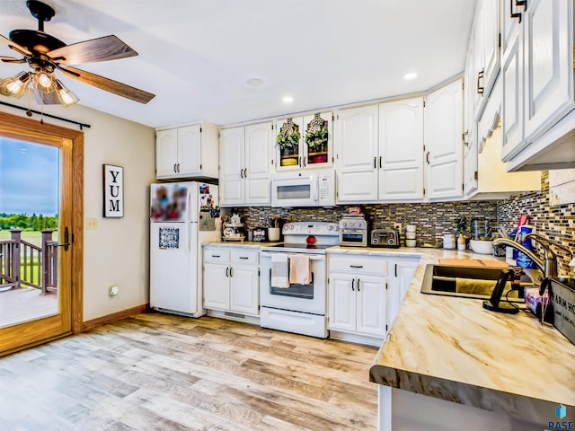 26481 487th Ave, Valley Springs, SD 57068 - kitchen with white appliances, a ceiling fan, decorative backsplash, light wood-style flooring, and recessed lighting