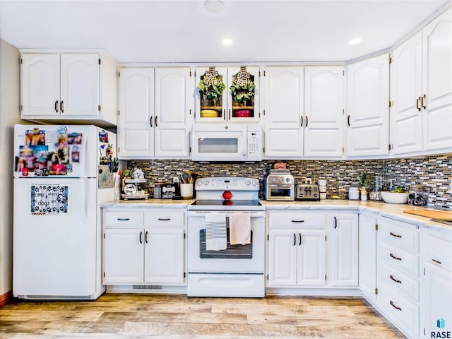 26481 487th Ave, Valley Springs, SD 57068 - kitchen featuring white appliances, white cabinets, light countertops, recessed lighting, and backsplash