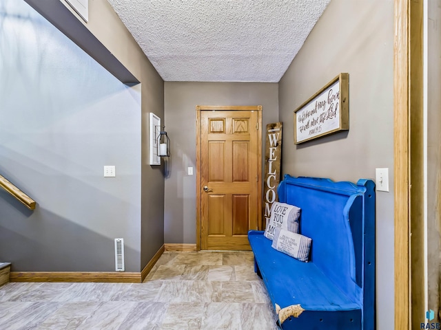 26481 487th Ave, Valley Springs, SD 57068 - foyer entrance with baseboards and a textured ceiling